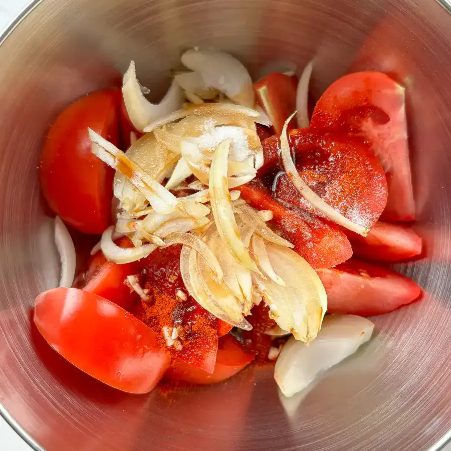 Tomato Kimchi Recipe: No Fermentation, Ready in 10 Minutes tossing fresh kimchi recipe tomatoes gently with spoon