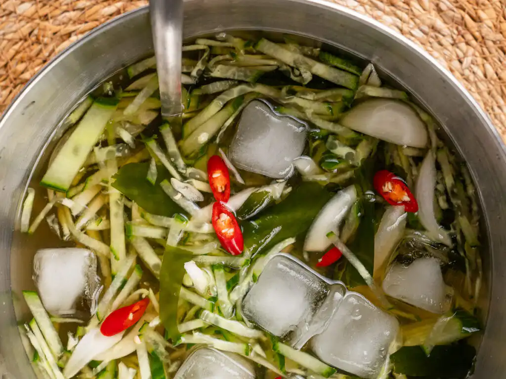 Korean Cucumber Soup (Oi Naengguk) - Best Cold Summer Soup Korean cucumber soup garnished with sliced red chili pepper