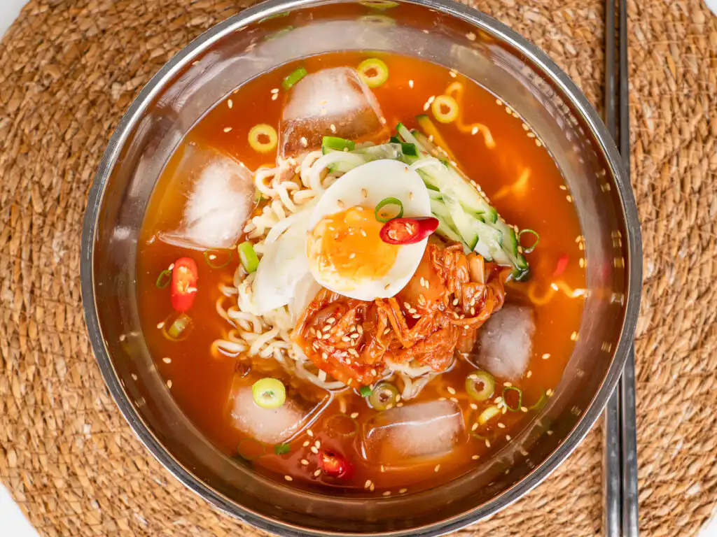 Grandma's Kimchi Korean Cold Noodles - Kimchi Mari Guksu Kimchi cold noodle recipe served in a traditional Korean bowl