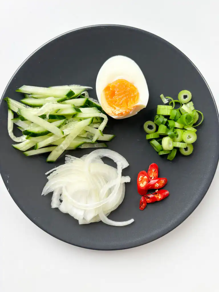 Toppings for cold ramyeon: egg, onion, pepper, spring onion, cucumber