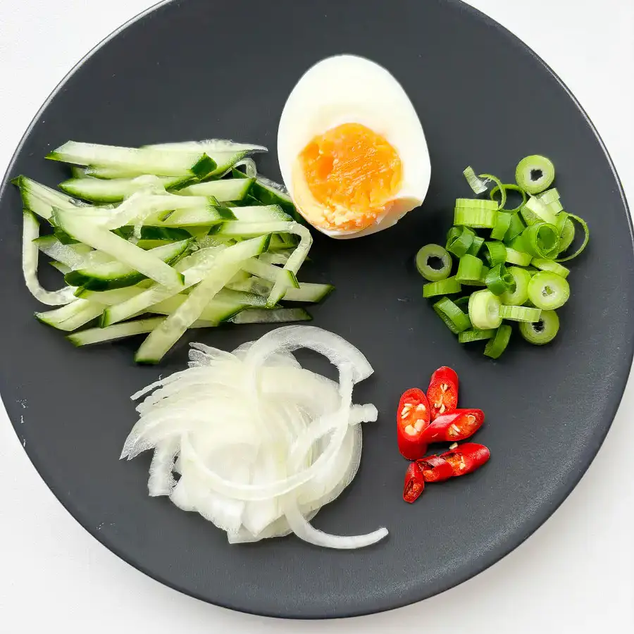 Toppings for cold ramyeon: egg, onion, pepper, spring onion, cucumber