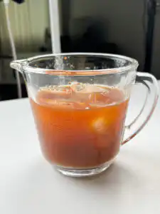Pouring cold water into the seasoning mixture for kimchi cold noodles