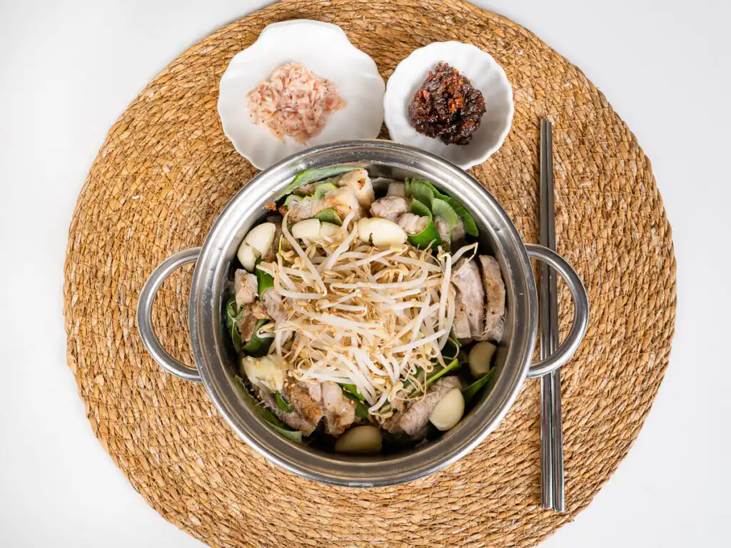 Spring Onion Bossam (Suyuk) – Juicy Waterless Pork Belly spring onion bossam pork slices with chopsticks and ssamjang bowls