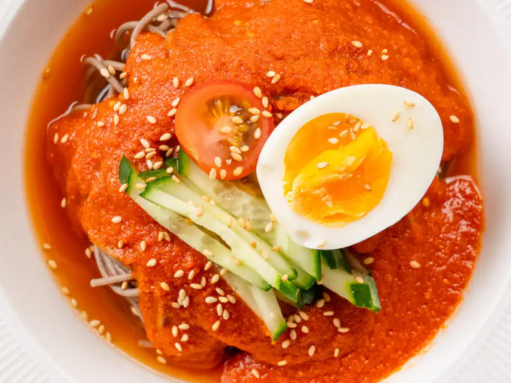 naengmyeon topping on the tomato gochujang bibim guksu