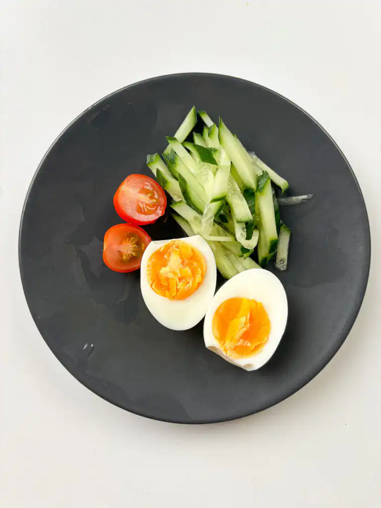Tomato Gochujang Bibim Guksu - Summer Spicy Cold Noodles julienned cucumber and halved boiled egg prepared as bibim guksu toppings