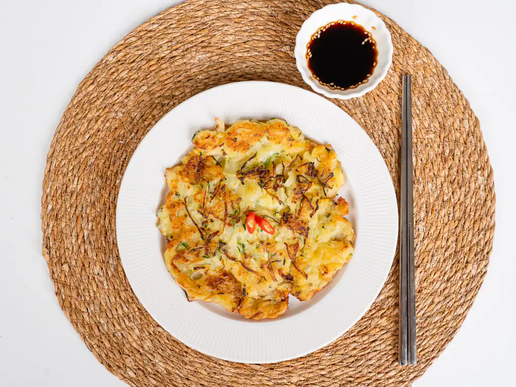 Zucchini korean pancake served with chopsticks