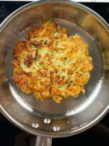 Korean zucchini pancake frying with crisping edges