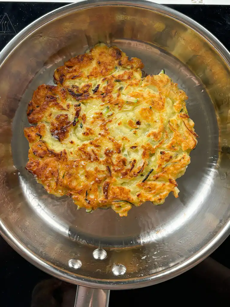 Korean zucchini pancake frying with crisping edges
