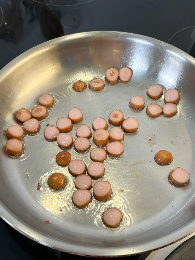 Buldak Fried Rice: Stress Blowing Buldak Sauce Rice in 10min Sausage slices frying golden brown in a pan to make buldak fried rice