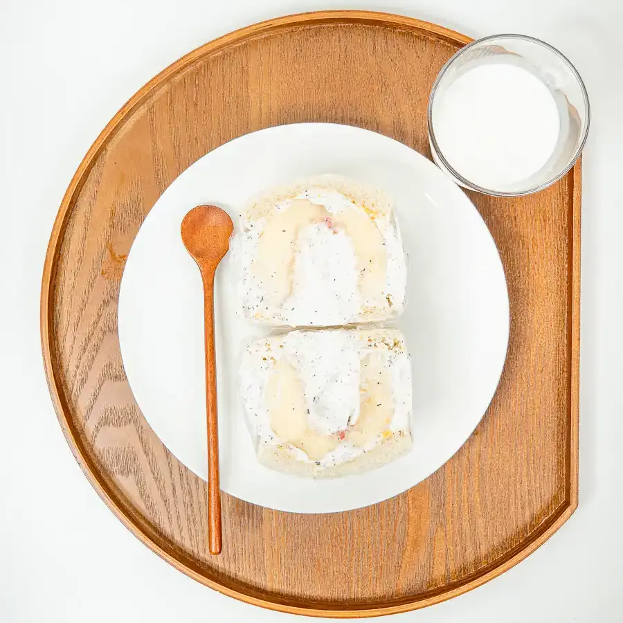 Earl Grey Peach Sando: Korean Cafe Fruit Sandwich Two halves of an Earl Grey peach sando displayed on a white ceramic plate.