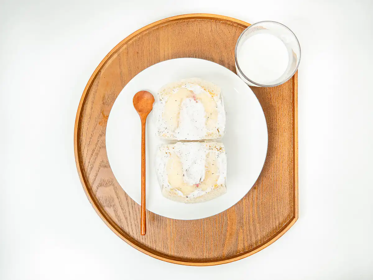 Earl Grey Peach Sando: Korean Cafe Fruit Sandwich Two halves of an Earl Grey peach sando displayed on a white ceramic plate.