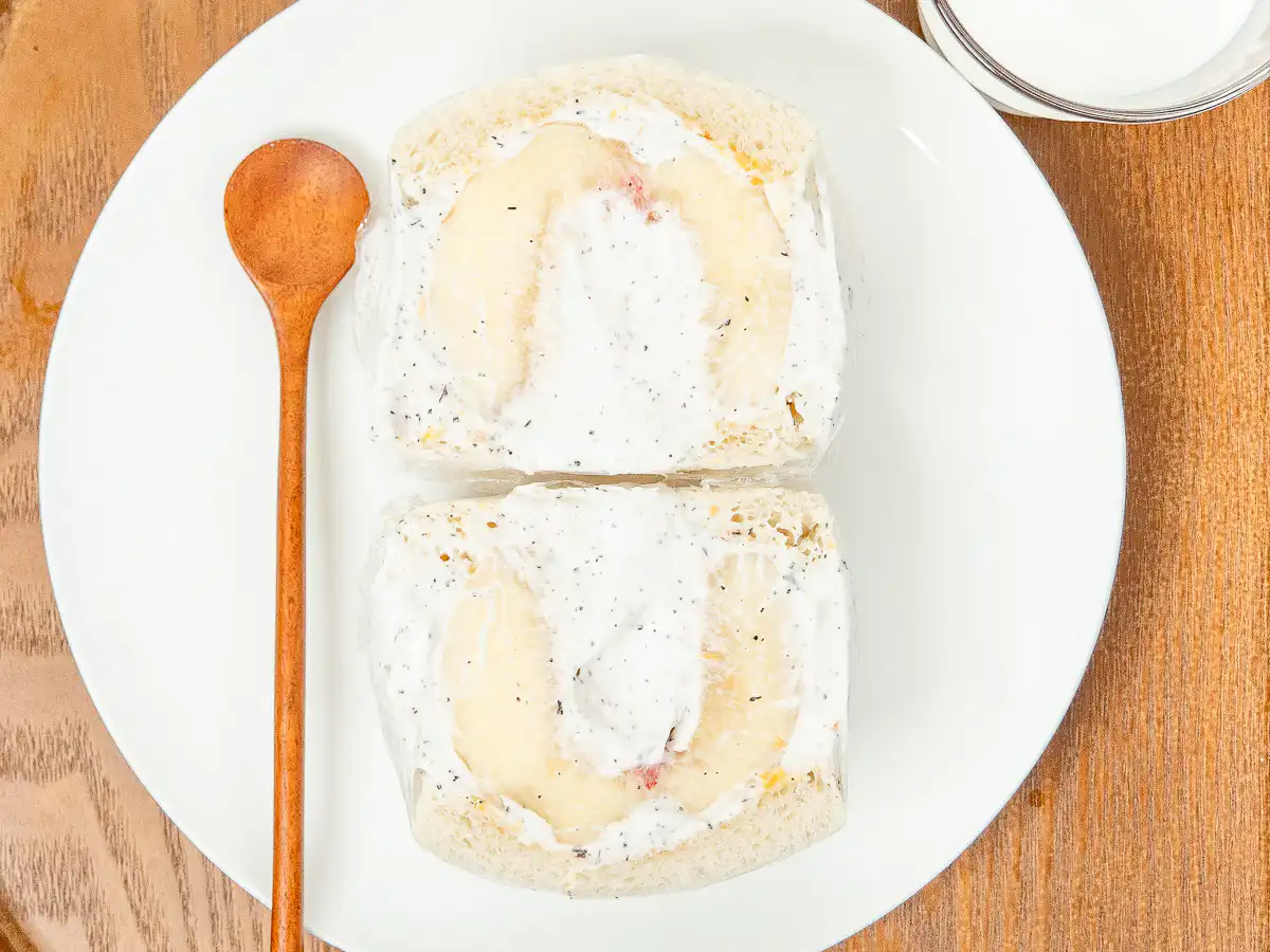 Earl Grey Peach Sando: Korean Cafe Fruit Sandwich Fresh peach sando sliced cleanly in half on a breakfast table setting.