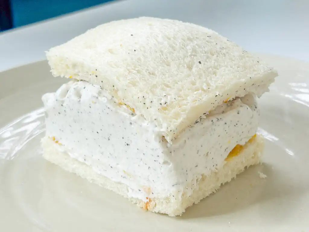Earl Grey Peach Sando: Korean Cafe Fruit Sandwich Placing the top slice of bread onto the cream-covered peach sando assembly.