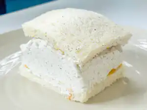 Earl Grey Peach Sando: Korean Cafe Fruit Sandwich Placing the top slice of bread onto the cream-covered peach sando assembly.
