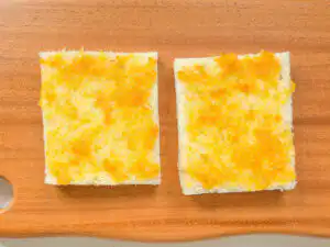 Earl Grey Peach Sando: Korean Cafe Fruit Sandwich Spreading orange marmalade jam onto two slices of white sandwich bread.