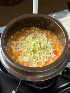 Tomato Rice Recipe: 10 Min Easy Cheesy Korean Pot Rice Garnish with a pinch of dried parsley and serve hot straight from the pot.
