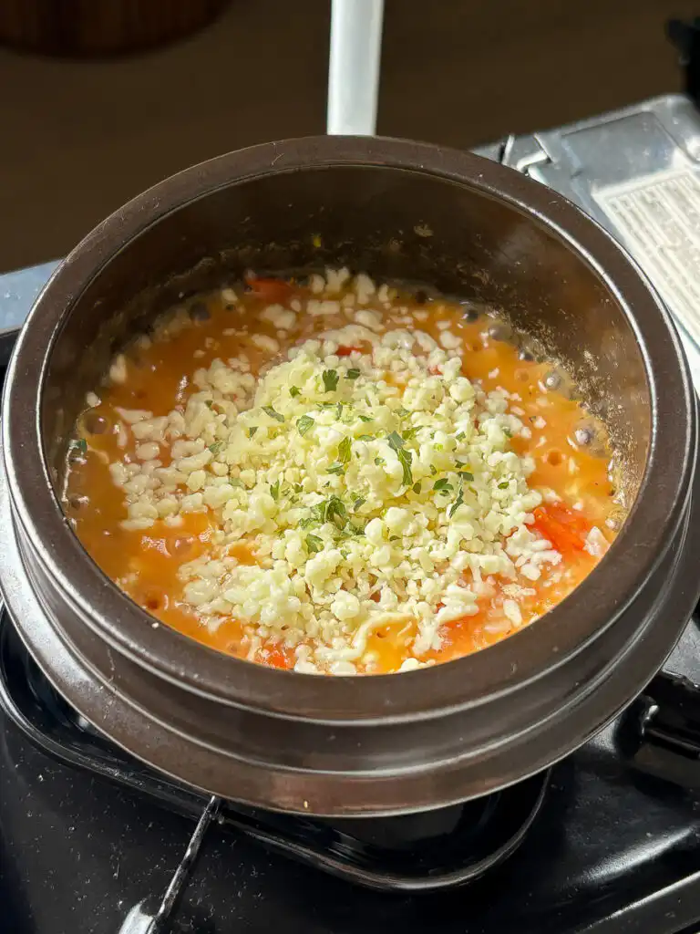 Garnish with a pinch of dried parsley and serve hot straight from the pot.