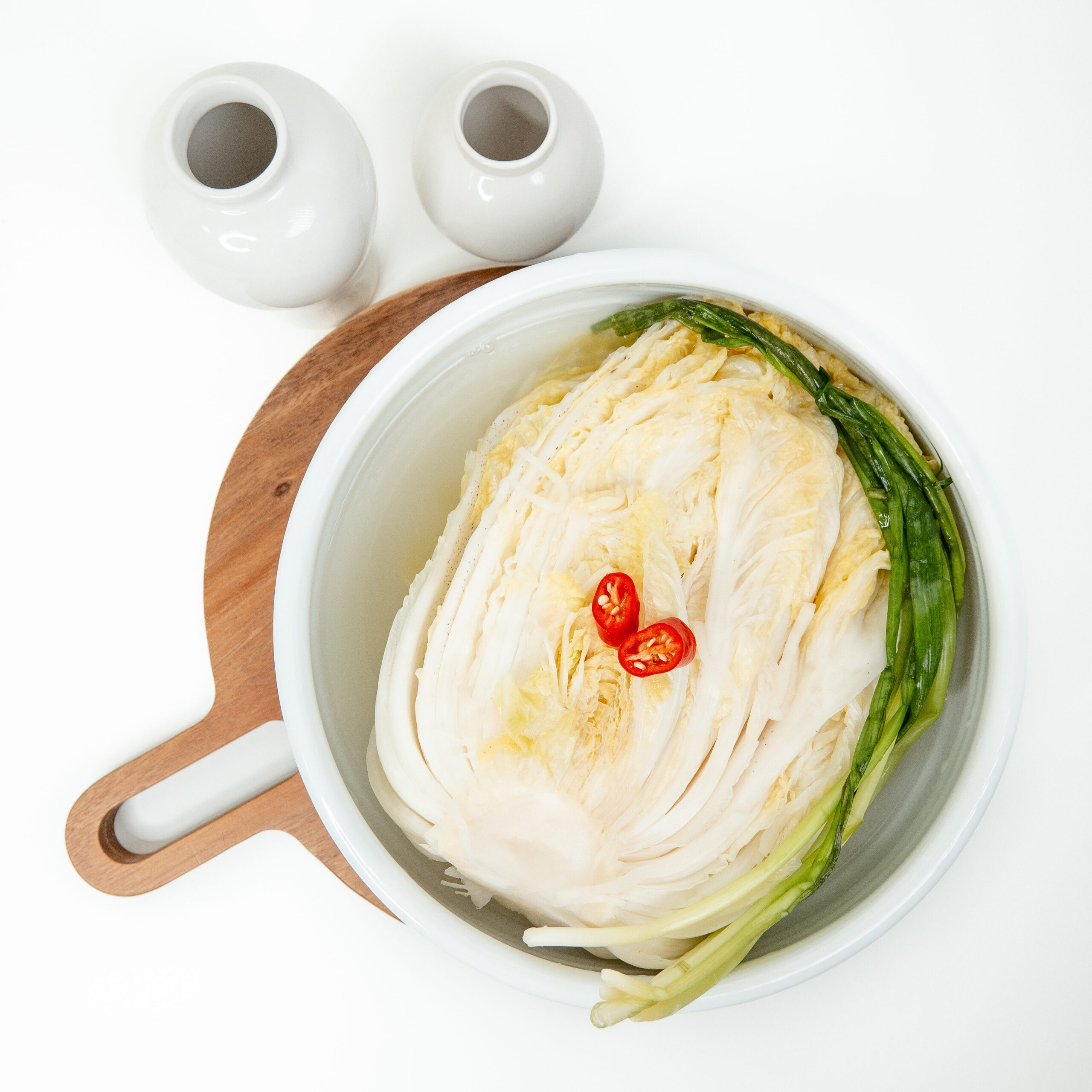 Napa cabbage brining in a large bowl for an easy non spicy kimchi recipe