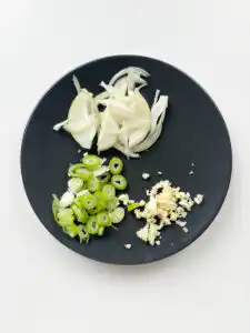 Korean Zucchini Rice Bowl: Easy Aehobak Deopbap Recipe Chopping green onions and mincing fresh garlic cloves