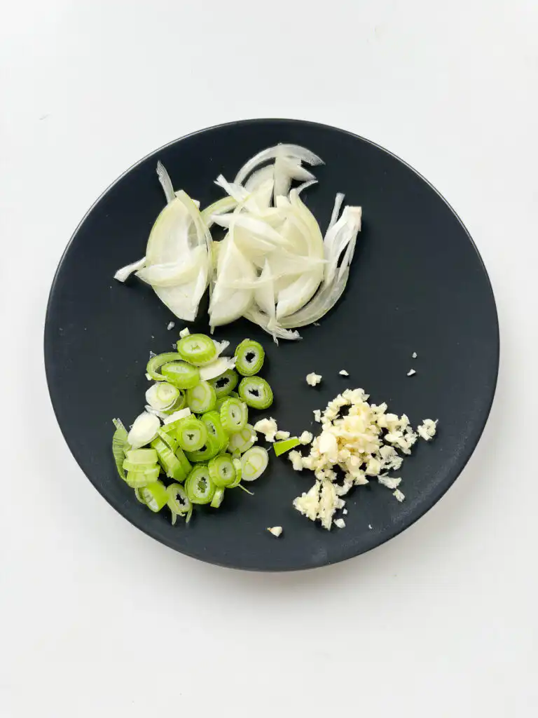 Korean Zucchini Rice Bowl: Easy Aehobak Deopbap Recipe Chopping green onions and mincing fresh garlic cloves