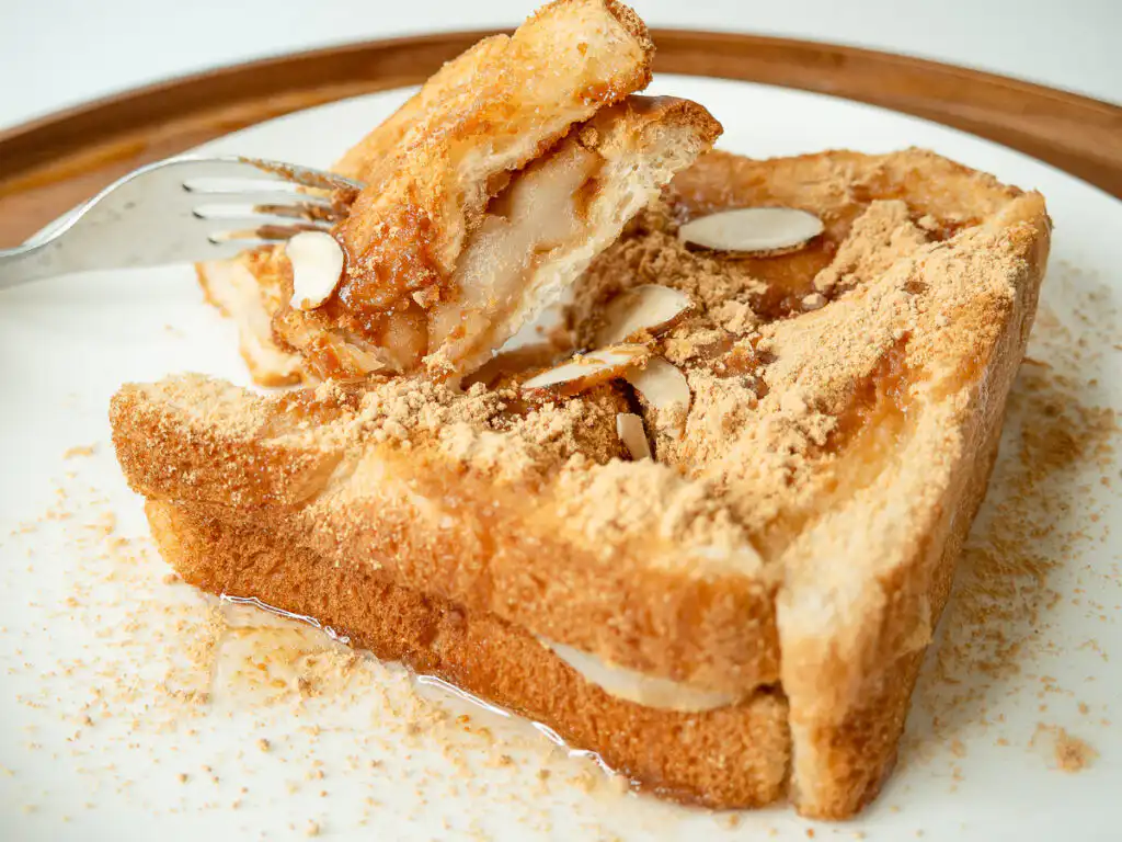 5 Min Injeolmi Toast: Easy Sulbing Toast with Korean Rice cake Melted stretchy injeolmi rice cake pulling out from crispy toasted buttered bread slices of injeolmi toast.
