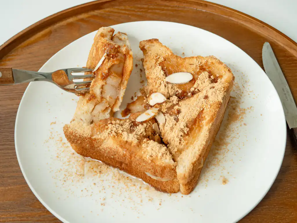 5 Min Injeolmi Toast: Easy Sulbing Toast with Korean Rice cake Beautifully plated sulbing toast surrounded by extra sliced almonds and roasted soybean flour.