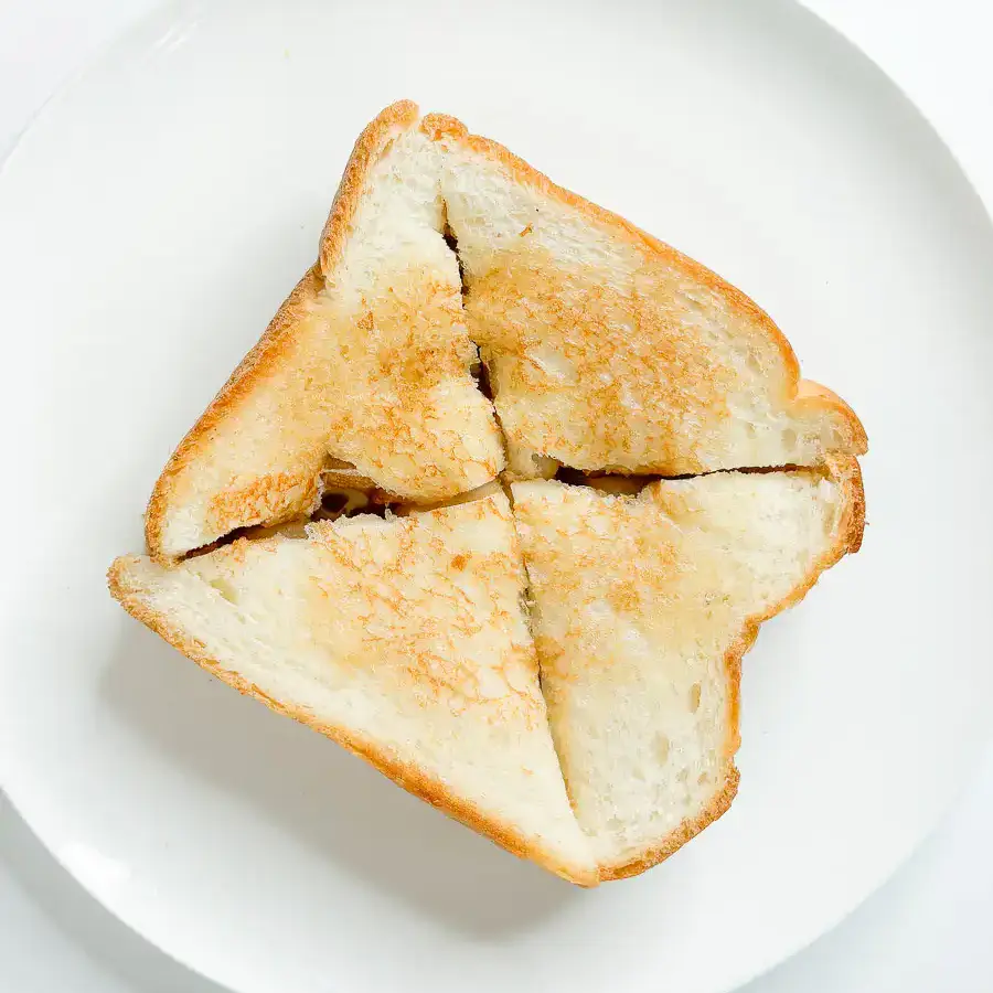 5 Min Injeolmi Toast: Easy Sulbing Toast with Korean Rice cake cut warm injeolmi toast into four equal quarter pieces