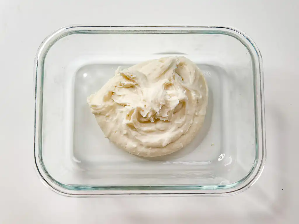 5 Min Microwave Injeolmi: Quick Korean Sweet Rice Cake Pouring hot water slowly from a kettle into the bowl of glutinous rice flour.