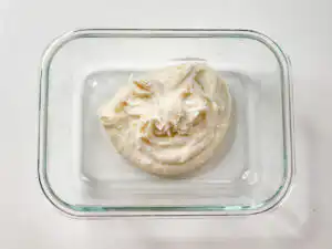 5 Min Microwave Injeolmi: Quick Korean Sweet Rice Cake Pouring hot water slowly from a kettle into the bowl of glutinous rice flour.