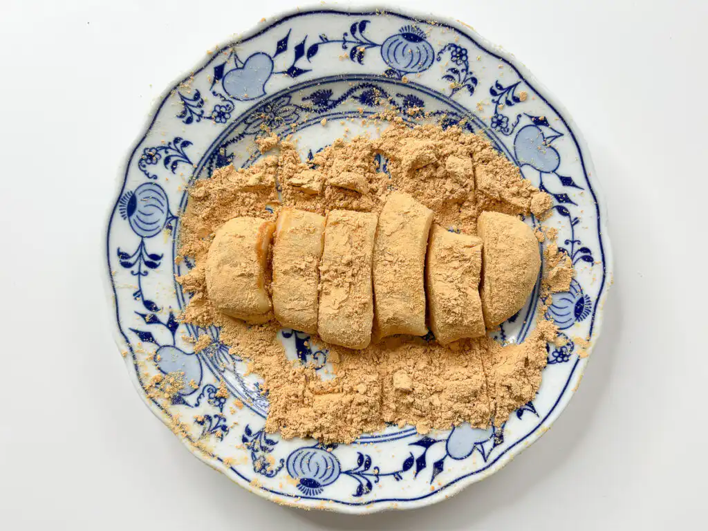 5 Min Microwave Injeolmi: Quick Korean Sweet Rice Cake Using a sharp kitchen knife to slice the coated rectangle into long strips.