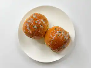 Korean Sweet Garlic Bread with Dinner Rolls: No Cream Cheese, Air Fryer Spreading sauce over the top of Korean garlic bread before air frying