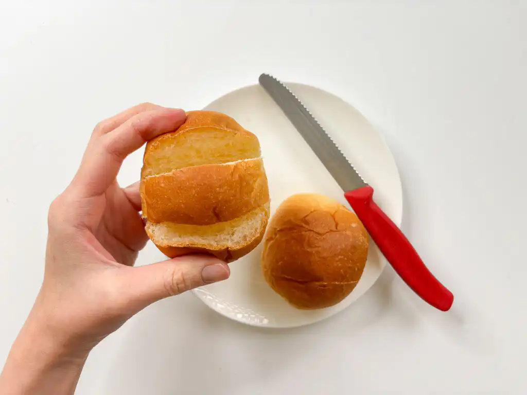 Korean Sweet Garlic Bread with Dinner Rolls: No Cream Cheese, Air Fryer Close-up of a scored dinner roll with two cuts for Korean sweet garlic bread