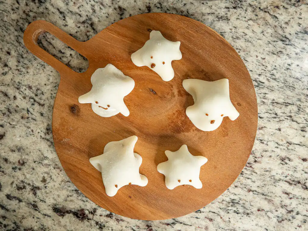 Halloween Ghost Mochi with Shine Muscat, 15-Min Microwave Overhead view of Halloween ghost mochi on a wooden plate