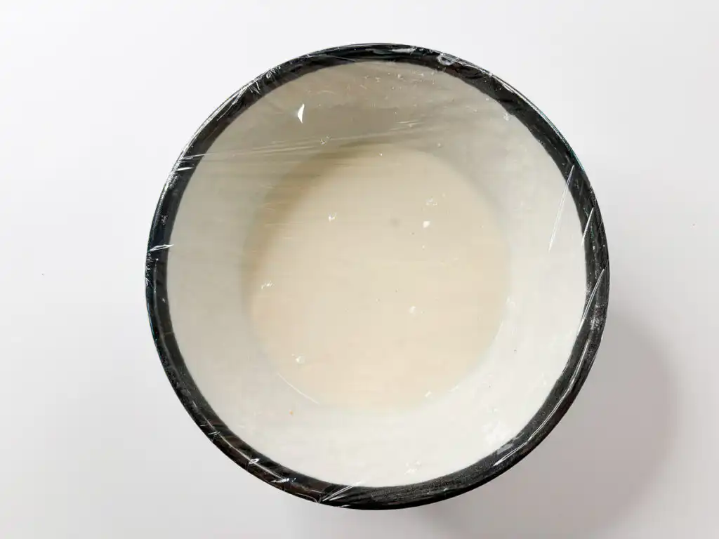 Microwave mochi dough with glutinous rice flour and milk in a bowl