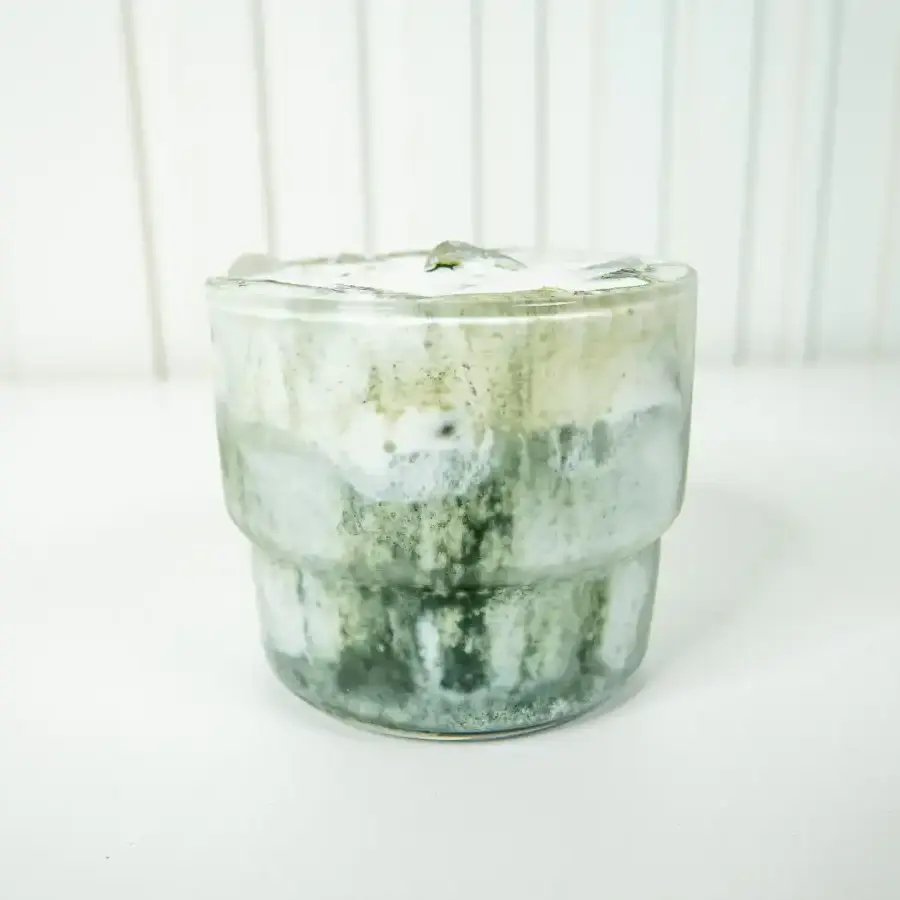 Korean Mugwort Latte: Easy Caffeine-Free Cream Ssuk Latte Close-up of green mugwort powder piled on top of cream foam on a Mugwort Cream Latte