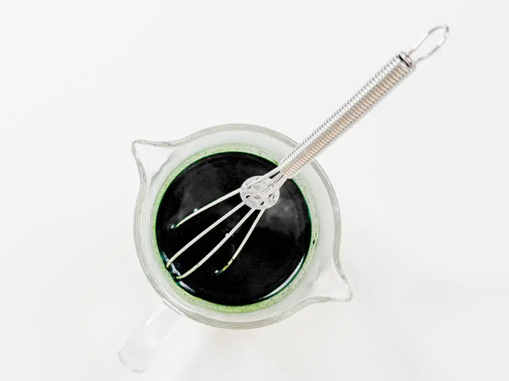 Korean Mugwort Latte: Easy Caffeine-Free Cream Ssuk Latte Mugwort powder dissolved in hot water into a deep green liquid, the base for Mugwort Cream Latte