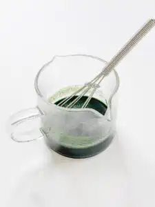 Korean Mugwort Latte: Easy Caffeine-Free Cream Ssuk Latte Mugwort powder dissolved in hot water into a deep green liquid, the base for Mugwort Cream Latte