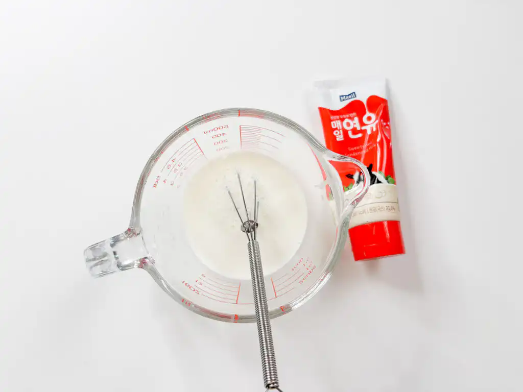 Cold milk and condensed milk starting to mix together, the milk base for Ssuk Latte