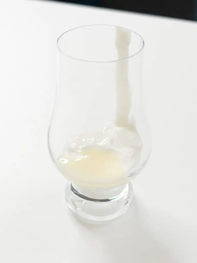 Condensed milk and whipping cream being mixed with a small electric frother as the cream foam rises, Ssuk Latte milk foam